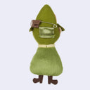 Green plush toy with a safety pin on a light gray background