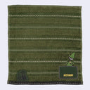 Green striped towel with Moomin character and logo on a light gray background
