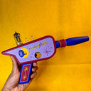 Wooden toy gun with branding that says "Moon Ray" in a retro style