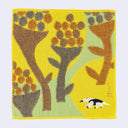Square yellow towel with artistic designs of large plants and a small anteater.