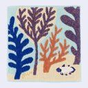 Decorative square towel with sealeaf and coral patterns on a light blue background. A small coelacanth fish swims in the bottom right.