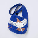 Dark blue fabric shoulder bag with an illustration of a white and brown bird spreading its wings.