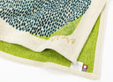Textile product with green and blue pattern on a white background