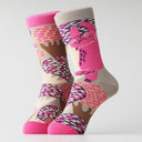 A pair of crew socks with a colorful abstract pattern featuring pink, purple, brown, and beige shapes on a light gray background.