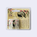 Blister packaging for a roll of washi tape stickers, designed by artist Morita MIW with a design of a feathery Turkey Vulture bird and stemmed flowers.