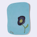 Postcard with a embroidered flower design on a light blue background
