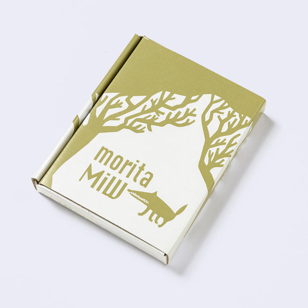 Decorative white cardboard gift box, with an olive green silhouetted illustration of a wolf and trees and branding for "morita MiW".