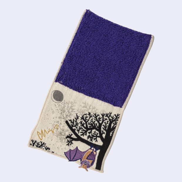Rectangular textile with a pocket, the top can be folded over to make it into a pouch. Interior is purple and exterior is beige with designs of a purple bat, a tree and a moon.