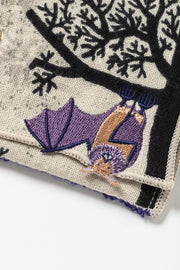 Embroidered pouch with a tree design featuring a purple bat hanging upside down.