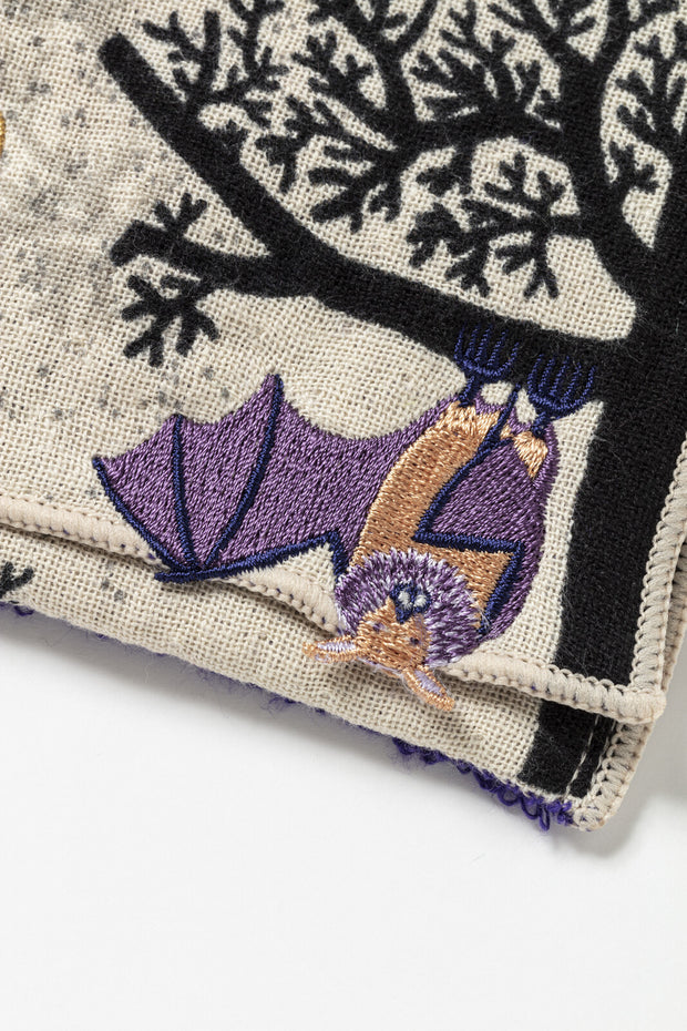 Embroidered pouch with a tree design featuring a purple bat hanging upside down.