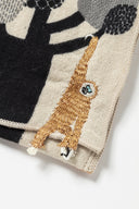 Embroidered fabric with a monkey design on a neutral background