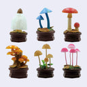 Set of colorful mushroom figurines on a white background
