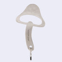 Metallic mushroom-shaped bottle opener on a light gray background