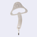 Metallic mushroom-shaped bottle opener on a light gray background