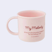 Back view of a short pink cup with a mug handle that reads "My Melody" with a small blurb about the character's personality.