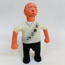 Toy figure with a white shirt and black pants on a white background