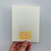 Back of cream colored greeting card, featuring information about the artist, Natalie Andrewson.