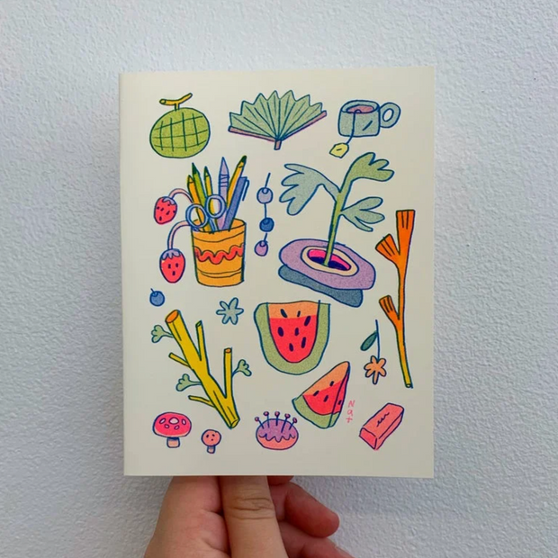 White greeting card with several illustrations on it, including a watermelon, branch, melon, tea, plant, etc.