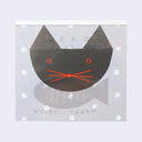 A square memo pad cover featuring a minimalist black cat face with red eyes, whiskers, and a red nose on a light gray background with white polka dots. The text 'NISHI SHUKU' appears at the bottom.