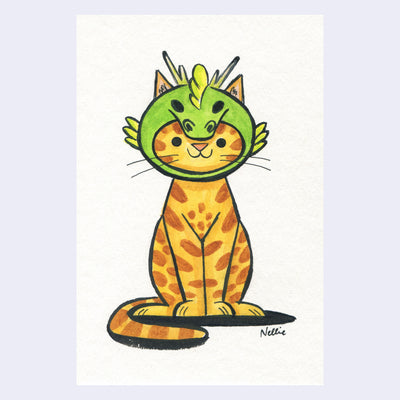 Watercolor of an orange cartoon cat wearing a dragon hat around its head.