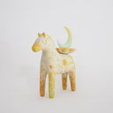 Horse figurine, painted cream with yellow color accents and sparkle shapes on it. Atop its back is a crescent moon resting on a flower.