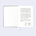 Open book spread showing the front inner cover, with cream colored pages and a written letter about the history of Giant Robot on the first page.