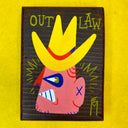Retro style painting of a face with a yellow hat on a wooden board, labeled 'Outlaw' on a yellow background.