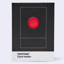 Pantone Card holder in a black box with a white bottom band and a red circle graphic on the front, photographed on a light gray background.