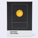 Pantone Card holder in its original packaging, featuring a black box with a minimalist yellow circle design and a white bottom section printed with 'PANTONE Card holder'.