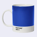 A ceramic mug with a solid blue exterior and a white handle and base, featuring the text 'PANTONE 286 C' printed in black on the white base.