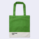 A green canvas tote bag with a white bottom panel featuring the black text 'PANTONE 3539', shown against a light gray background.