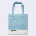 A light blue canvas tote bag with a white Pantone 550 color block at the bottom and black text, shown against a light gray background.