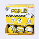 A box of Peanuts Snoopy Figures by Cool Things, showing a bright yellow retail package with Snoopy graphics and several yellow-and-white surprise balls inside.