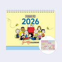 Peanuts 2026 desk calendar with the characters gathered as a group with a sticker sheet shown as an added bonus