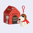 Plush clip-on Snoopy toy with packaging on a light gray background