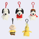Set of five small plush toys with red clip attachments on a light gray background