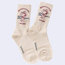 Pair of beige socks with a graphic of Snoopy dressed as a Beagle Scout with 50 Year text.