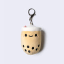 Plush keychain shaped like a bubble tea with a happy face.