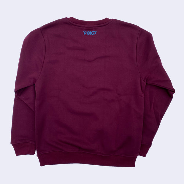 Back of a deep burgundy sweatshirt, with "Peko" written in blue font in the top center near the collar. 