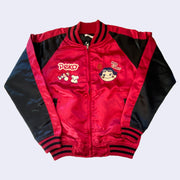 Shiny red bomber jacket with black sleeves and small embroideries on the chest of Peko Chan, a smiling girl with rosy cheeks and candy accessories.