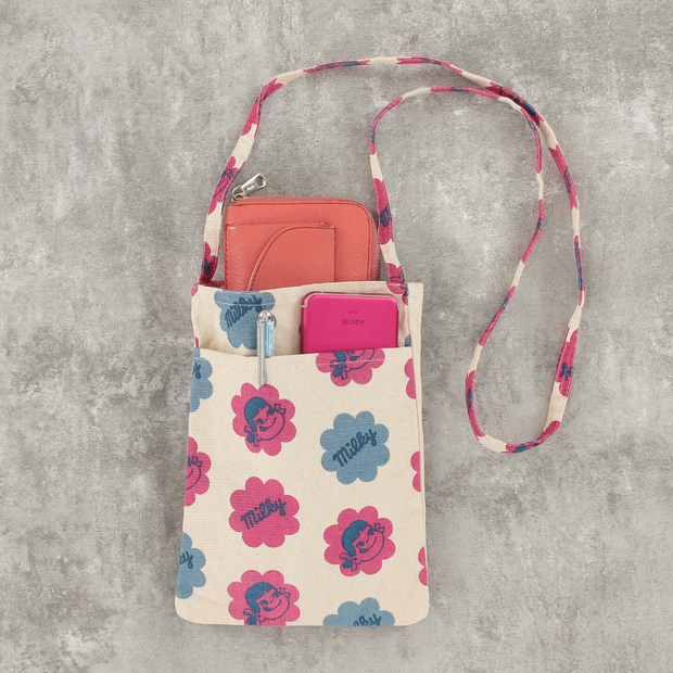 Peko Chan patterned crossbody shoulder bag, shown filled with various items in its outer pocket and a wallet peeking out of its main pouch.