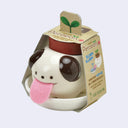 Dog shaped planter with a pink felt tongue and encased in packaging.
