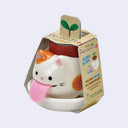 Cat-shaped planter with pink tongue and 'Peropon' packaging on a light gray background