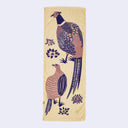 Beige towel with purple pheasant design on it.