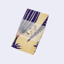 Folded towel with a paper sleeve.