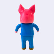 Back view of a hot pink vinyl figure, with a large pig head and a blue business suit with gold shoes.