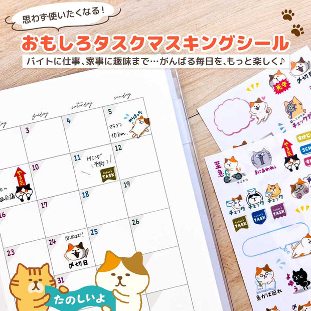 Calendar with cute cat-themed stickers on a wooden surface