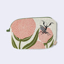 Oval shaped beige pouch with a green zipper on the side, featuring rounded pink flowers like mums and green leaves. On top of the flowers is a black praying mantis, with its arms extended out showing its wings. 