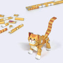 Paper sculpture of an orange tabby cat, made out of folded paper pipes. It stands next to its paper pipe parts.