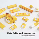 Partially assembled paper sculpture of an orange tabby cat, made out of cut paper pipes.